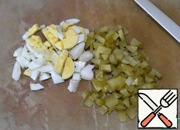 Eggs and pickled cucumbers are also cut into cubes.