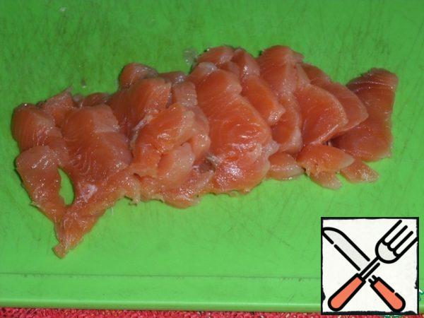 Lightly salted red fish cut into slices and put on pancakes on top of cottage cheese.