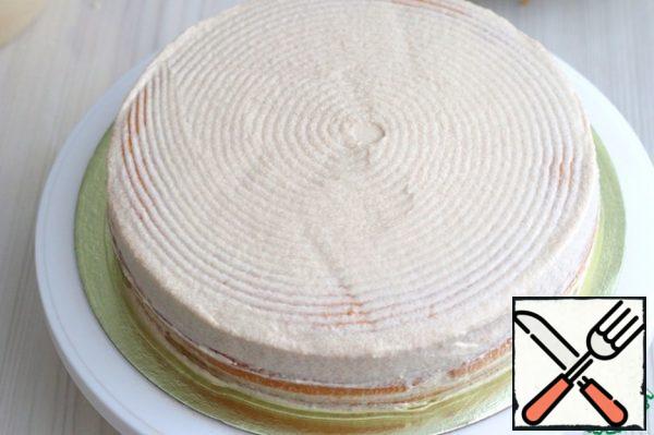 Align the sides and top of the cake with Sundae cream. I would like to say a few words about sprinkling the side of the cake. When preparing cakes and pastries, a small amount of dried crumb remains. The crumb can be crushed in a grinder, then placed in a jar and stored in the refrigerator for a long time. This crumb may come in handy later when sprinkling biscuit cakes and pastries. You can add cocoa powder to the crumb, as in my case, and sprinkle the side of the cake.