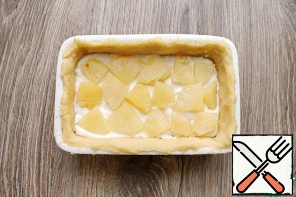 Add the curd filling and flatten. Lay pineapples on top.