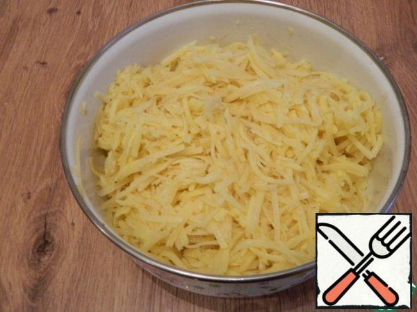 Grate potatoes on a coarse grater.