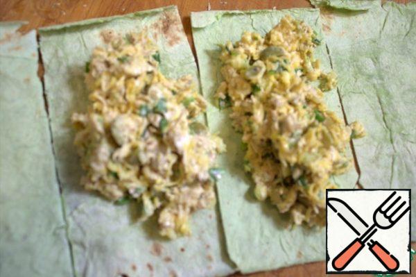 Cut thin pita bread into rectangles or squares.