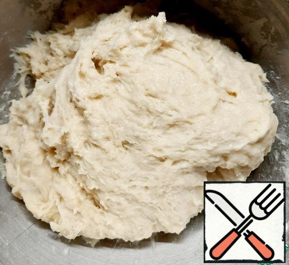 Knead a soft, slightly sticky dough.
Grease the bowl with vegetable oil, put the dough, cover with a film, put it in heat until it increases in volume by 2 times.