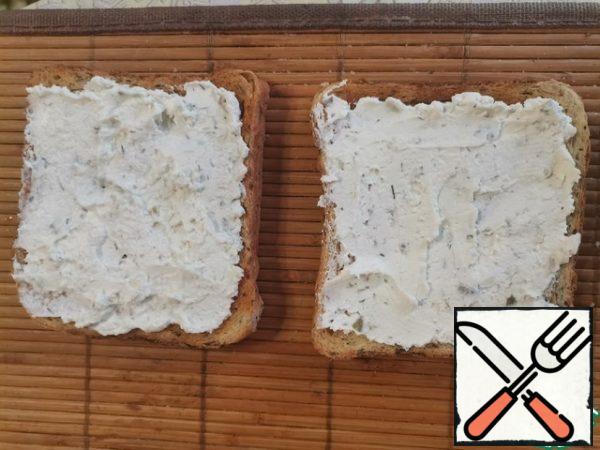 Curd cheese in a blender is mixed with pickled gherkins. Or we buy ready-made cottage cheese with pickles in the store. Spread the toast with cheese.