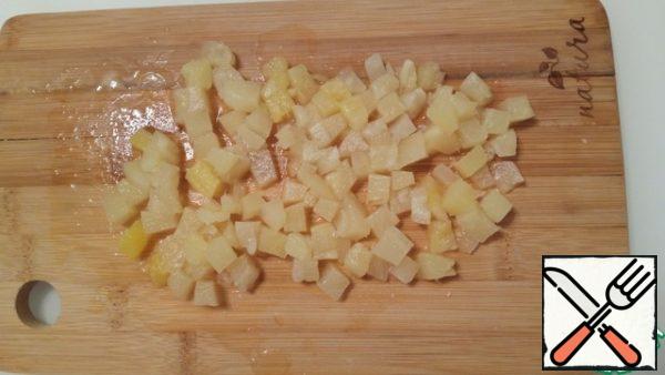 We cut the pineapples into small cubes. My pineapples were already in pieces, but I still crushed them a little. It took a little more than half of the jar.