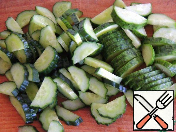 Cucumbers are washed and cut into half rings.