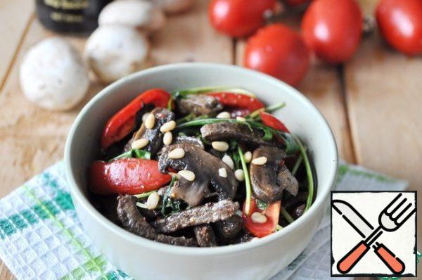 Serve the salad warm, sprinkled with pine nuts.