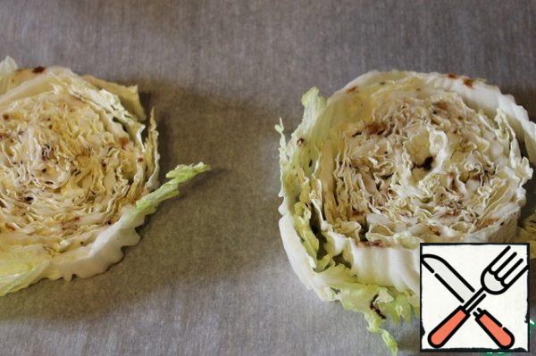 Put the cabbage on a baking sheet covered with parchment, pour the dressing on top.