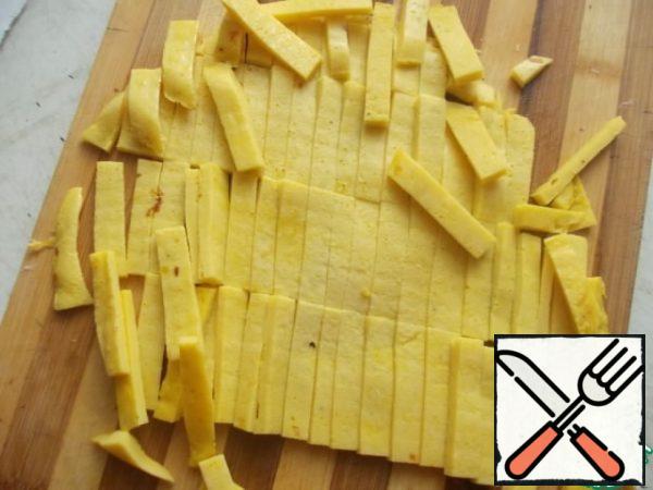 Beat eggs with flour and milk, add salt to taste. and fry on a low heat, in a greased frying pan. Cool slightly and cut into slices.
