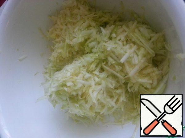 Grate the zucchini on a coarse grater, add 1 tsp of salt and leave for 20 minutes to give the juice.