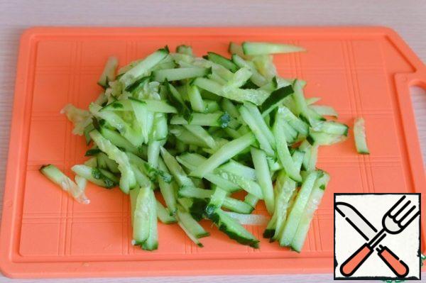 Chop the fresh cucumber into strips.