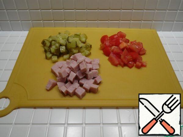 Cucumbers, ham and tomatoes cut into small cubes.