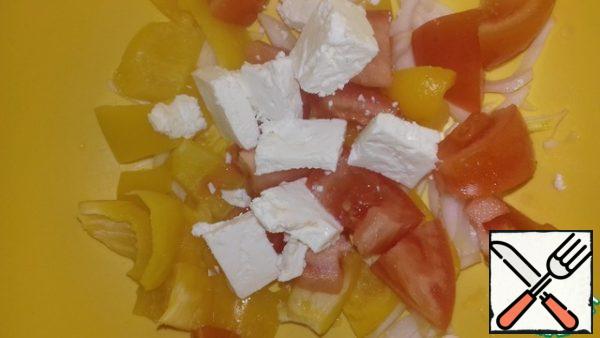 Cut the pepper, tomato and feta into a large cube. Onion in half rings. We drain the liquid from the mushrooms and add it to the vegetables