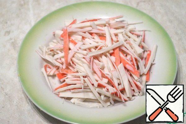 Cut the crab sticks into strips.