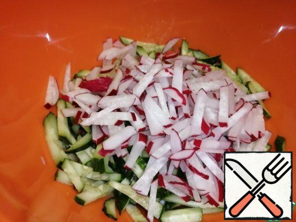 Radish is also cut into long strips and sent to a bowl with the rest of the ingredients.
