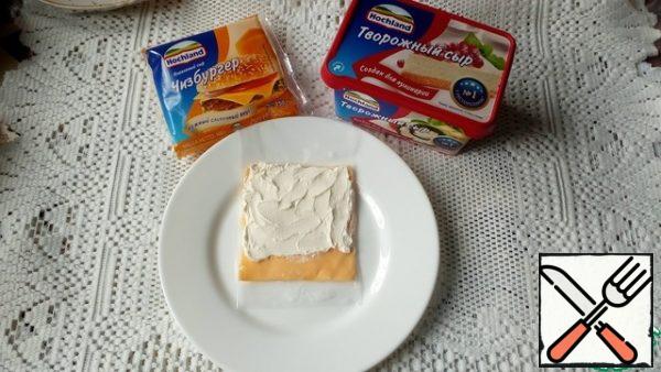 Spread the remaining curd cheese with a teaspoon on top of the slices of melted cheese.