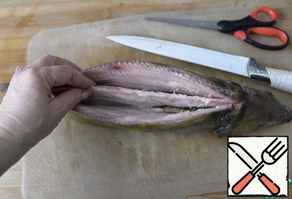 Clean the fish, cut off the fins, tail. We remove the gills, mine. With a sharp knife we ​​make cuts along the ridge, cut out the ridge. We remove the insides.