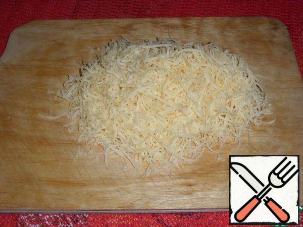 Grate cheese on a grater.