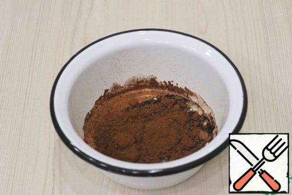 Next, add 15 gr to the milk-oil base. cocoa powder. Stir the mixture with a culinary spatula.