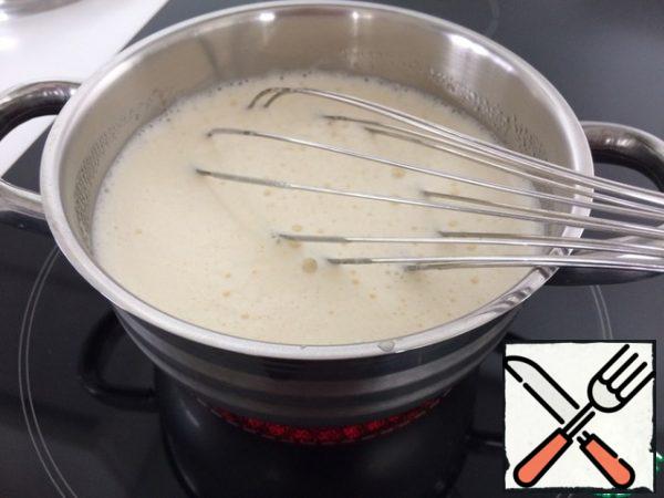 Add milk and place on the stove. Cook, stirring constantly until boiling. After boiling, the cream will have the consistency of "thick sour cream".