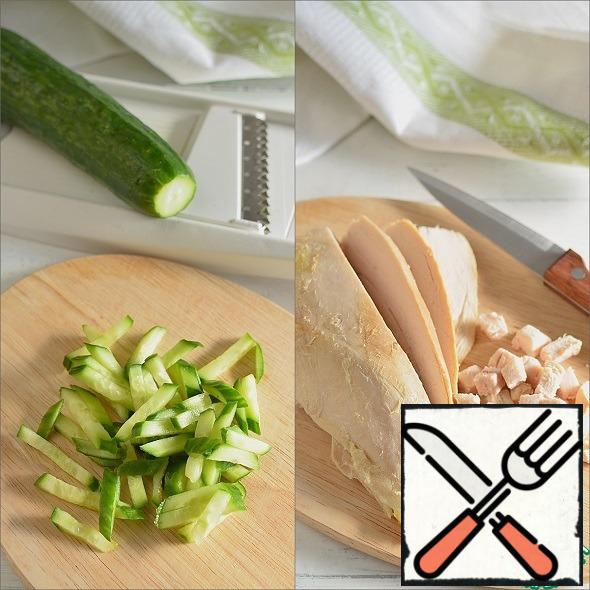 Cucumbers cut into strips. Cut the chicken breast into cubes.