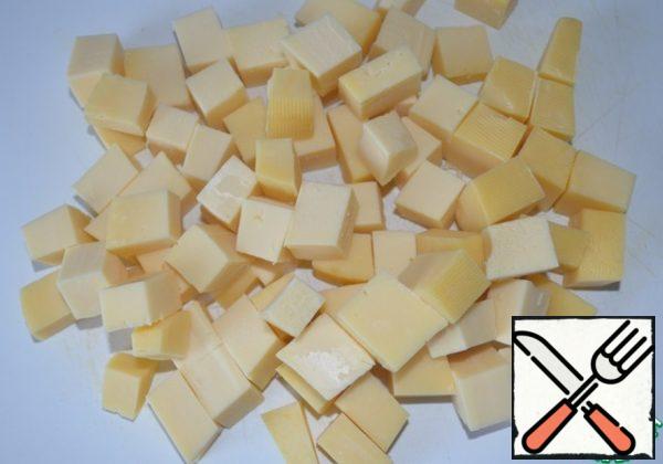 Cut the cheese into small cubes.