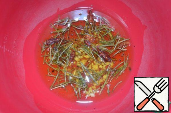 Prepare the marinade!
Mix the olive oil with garlic, vinegar, black pepper, chili pepper, rosemary needles and dried tomatoes.