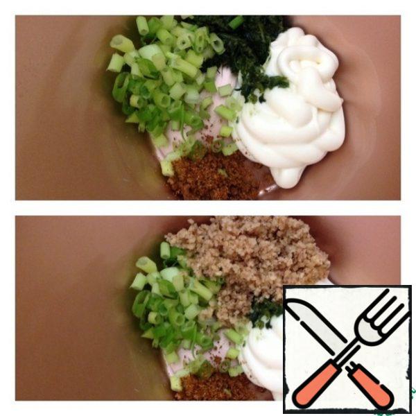 Finely chop the greens, cut the green onion into small rings.
Add sour cream/mayonnaise, a little salt and adjika (if not, replace with hot ground red pepper and preferably flakes).
Finely chop the garlic (do not pass through the press).
Chop the nuts with a blender or roll them through a meat grinder. Knead the sauce thoroughly.
Place the eggplants on a plate and top with the resulting sauce.