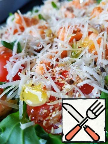 Grated parmesan.
Add the olive oil, squeeze the juice of half a lemon over the salad. Add a little salt and pepper.