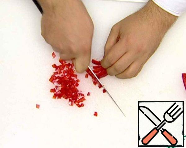 Peel the bell pepper, cut it into small cubes, and put it in a bowl