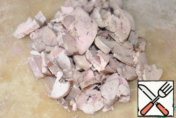 Chicken liver is boiled for 10 minutes in salted water. Let it cool. Cut into thin slices.
