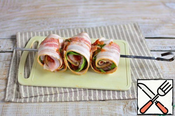 Similarly, we form and string 2 more rolls on the skewer.