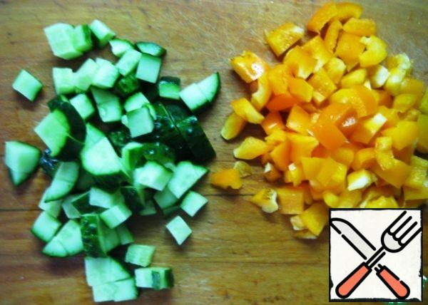 Cucumber and bell pepper cut into small pieces.