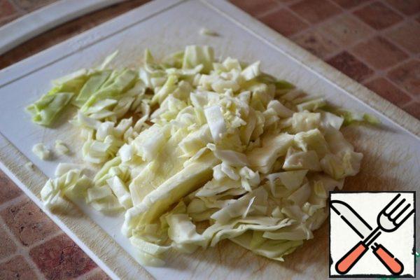 Finely chop the cabbage, rub it with your hands.