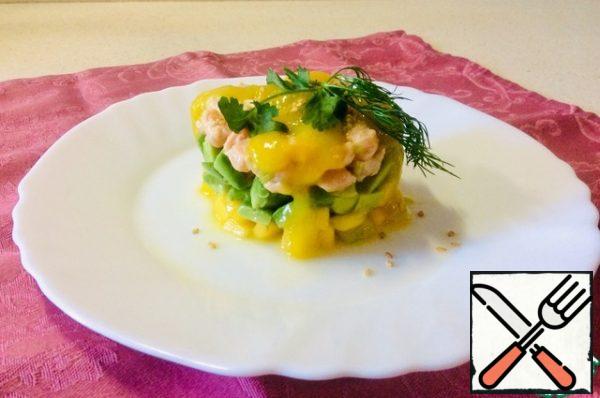 Before serving, collect the rainbow snack in a ring or mold. Approximately the same layers: from the bottom of mango, avocado is in the middle, on top of salmon. Pour over each serving 1 h. l. mango puree and a few drops of sesame oil, sprinkle with sesame seeds and garnish with herbs.