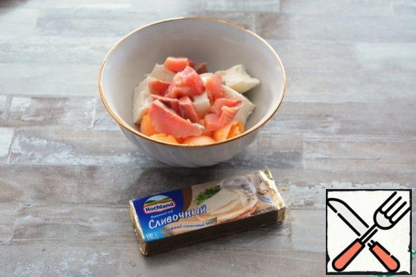 To the yolks, add the melted cheese, pieces of lightly salted salmon and a couple of spoons of mayonnaise.