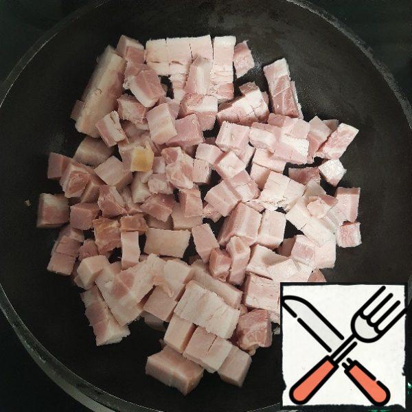 Cut the bacon or brisket into small cubes and fry in a dry pan.