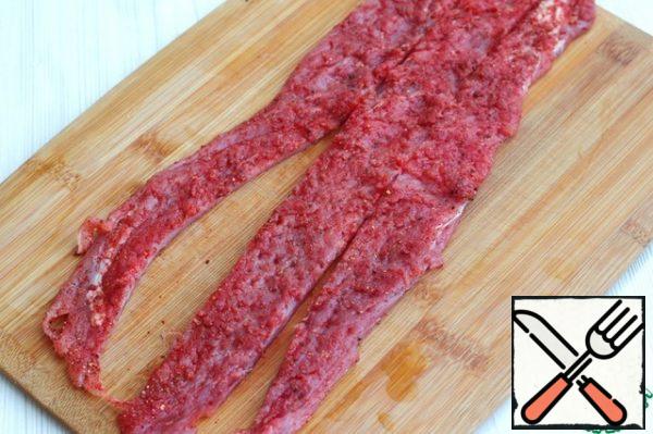 Cut the tenderloin strips lengthwise into three pieces.