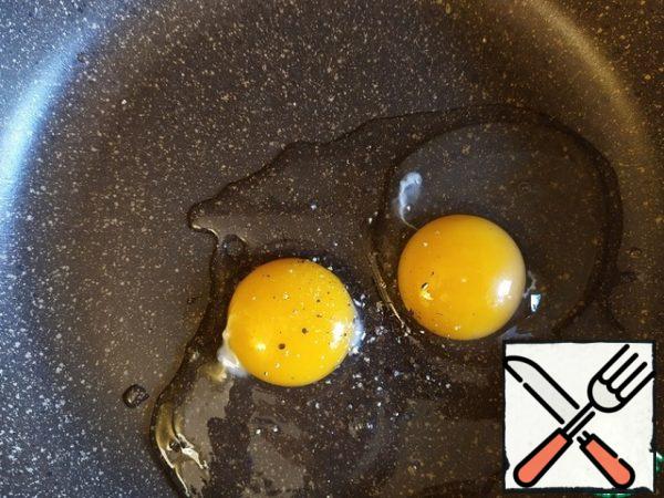 Break the eggs into a large, flat dish (where the breast will fit). Season with salt, pepper, and mix.