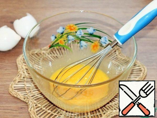 Separate the whites from the yolks. Beat the yolks with a whisk.