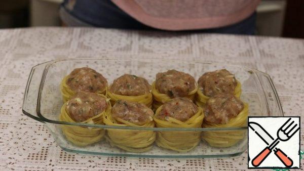 In the center of each nest, we lay out a ball of minced meat.