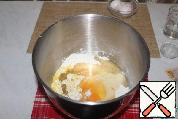 Add the eggs, zest of one lemon and vegetable oil.