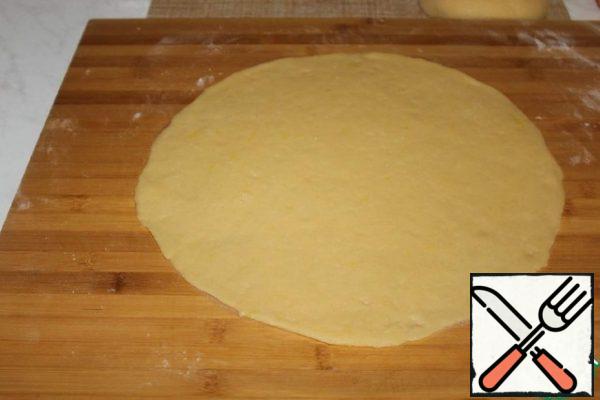 Roll out one piece of dough on parchment.