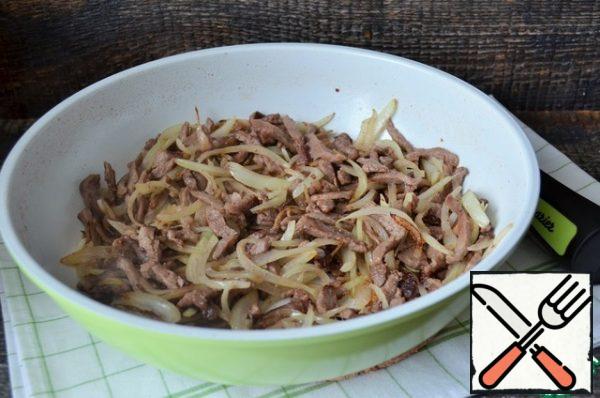 Add onion feathers, fry for 3 minutes, add salt.