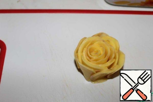 In a circle, add slices forming a rose.