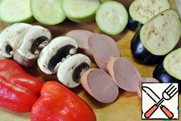 Mushrooms, zucchini, eggplant cut into large pieces. cut the pepper in half. Sausage cut into slices.