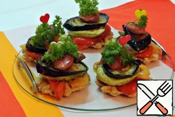 On each oatmeal waffle, put the grilled vegetables, shpikachki. Pierce with a skewer for stability. Garnish with herbs.
You can serve Tsakhton sauce: pour dry adzhika into the sour cream, add grated garlic, finely chopped coriander and parsley. Season with salt and pepper.