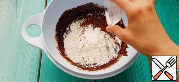 Then I add all the dry ingredients, flour, cocoa and baking powder and mix everything again.