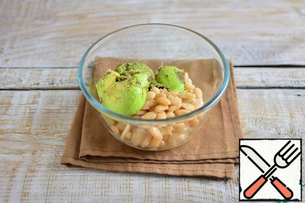 Using a slotted spoon, remove the beans to the bowl and add the avocado pulp.