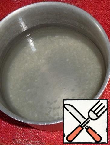 We measure out the right amount of rice. We wash it with water. In a saucepan, put the washed rice. Add water and salt.